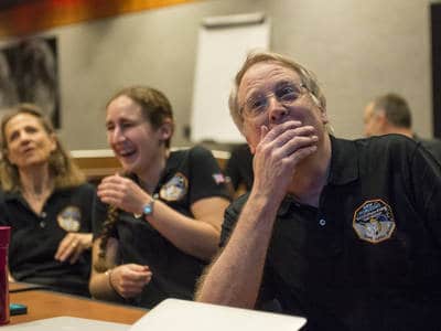Members of the New Horizons science team react to seeing the spacecraft's last and sharpest image of Pluto before closest approach later in the day, Tuesday, July 14, 2015 at the Johns Hopkins University Applied Physics Laboratory (APL) in Laurel, Maryland. Photo Credit: (NASA/Bill Ingalls)